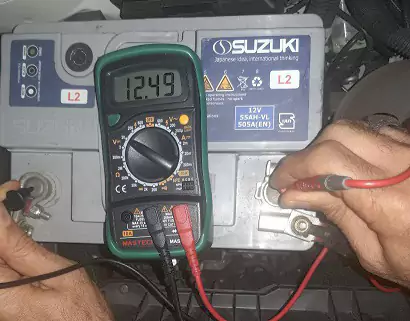 تصویری از مولتی متر گیری یکی از اجزای برق خودرو در آموزش ربرق خودرو
